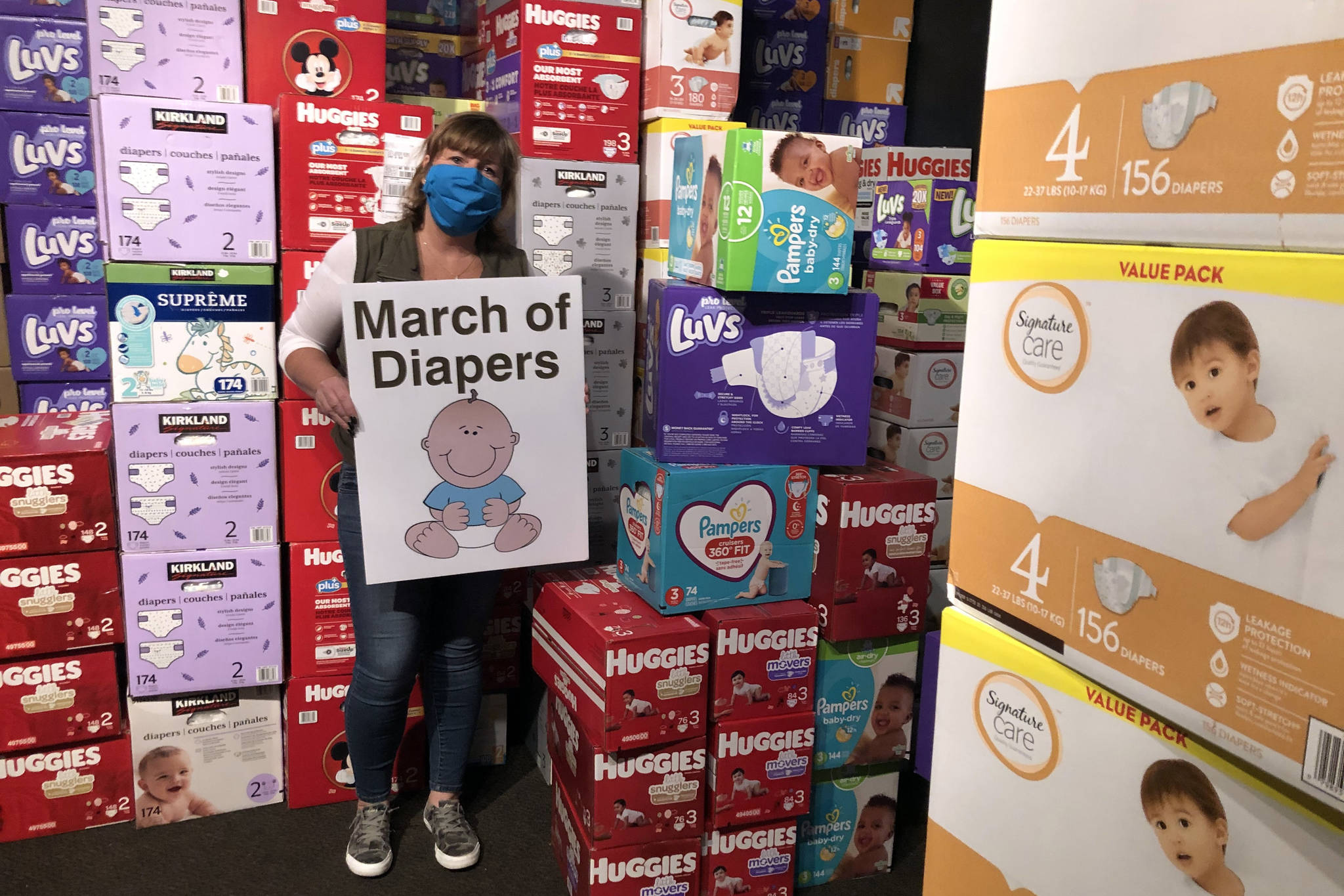 Cheryl Hurst stands among the thousands of diapers being stored at Billy McHale’s in Federal Way as part of the annual March of Diapers charity drive. (Photo by Andy Hobbs/Federal Way Mirror)