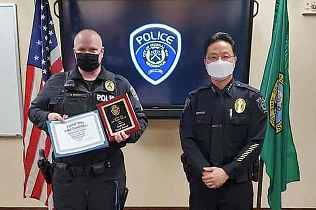 Cpl. Grant Bassett, left, and Federal Way Police Chief Andy Hwang pose for a photo after the presentation of the 2020 Officer of the Year award on May 25. Photo courtesy of FWPD