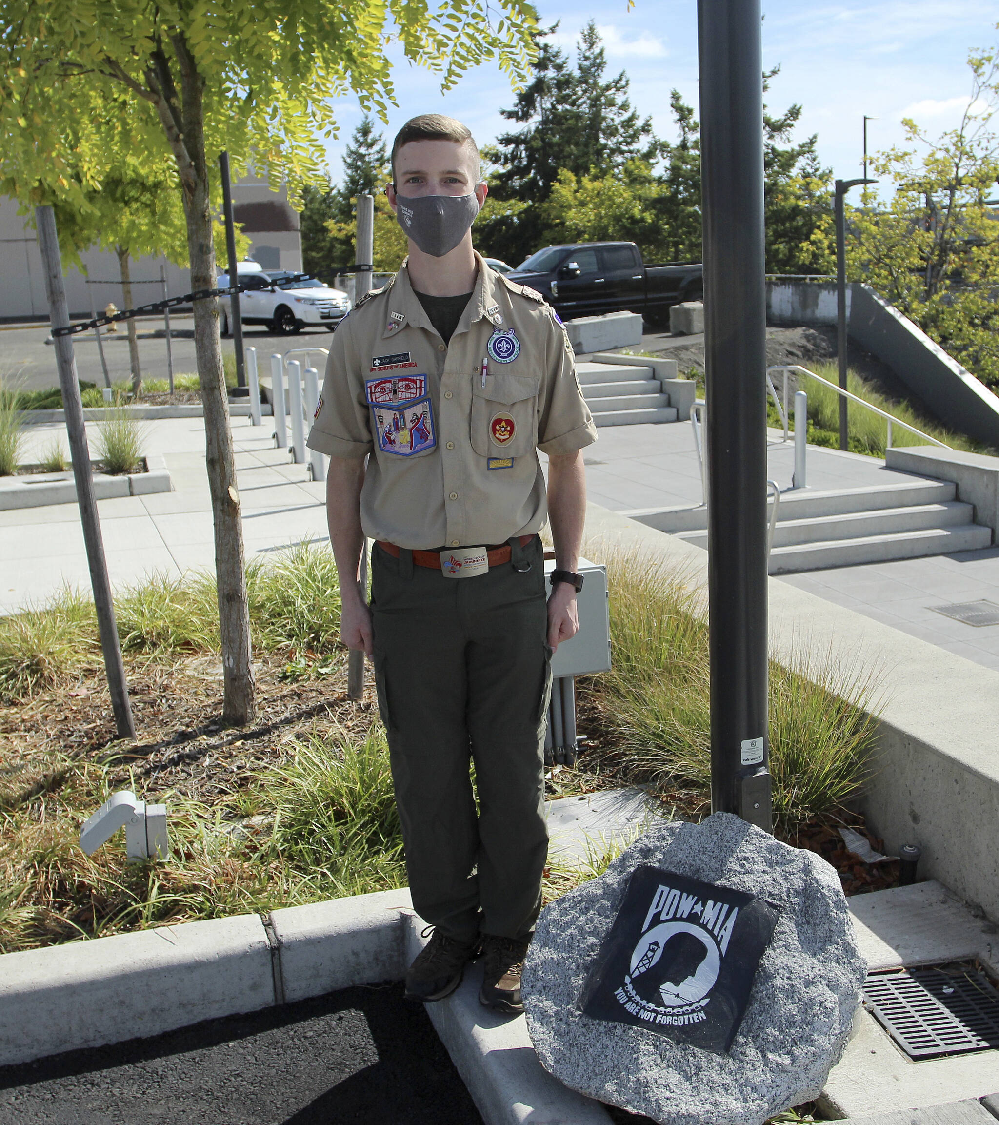 Jack Garfield, 17, carved and painted a stone at the veterans memorial to honor Prisoner of War (POW) or Missing in Action (MIA) service members. Olivia Sullivan/the Mirror