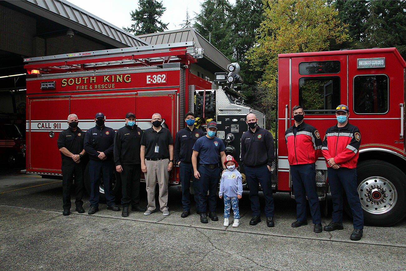 Arianna Graham, center, stands with members of South King Fire & Rescue. Olivia Sullivan/the Mirror