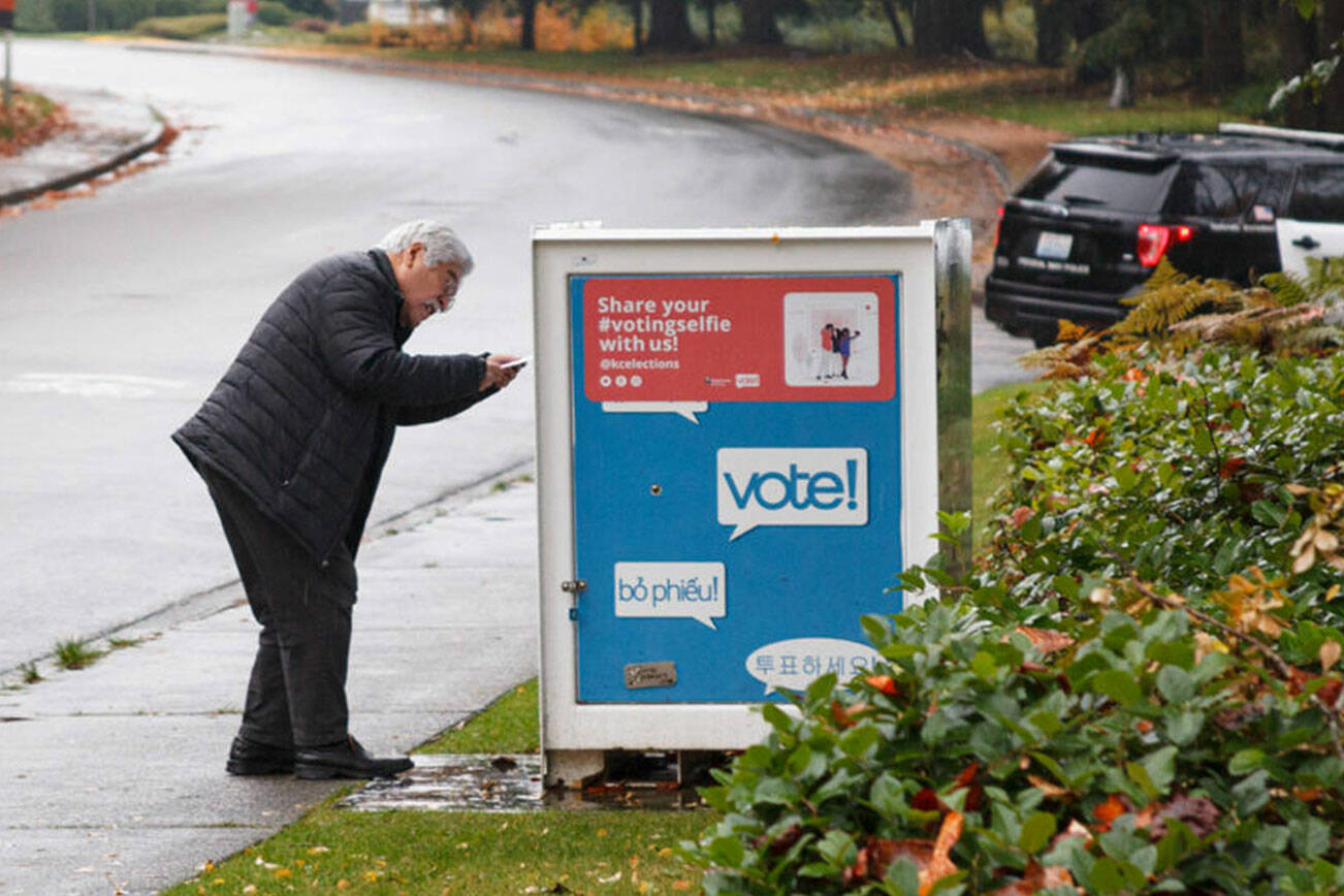 A voter drops off their ballot for the King County general election on Nov. 2, 2021. Henry Stewart-Wood/Sound Publishing