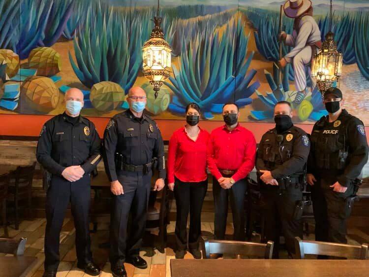 Manager Jaime Monje stands with Federal Way Police Department members inside the Federal Way Azteca. Courtesy photo