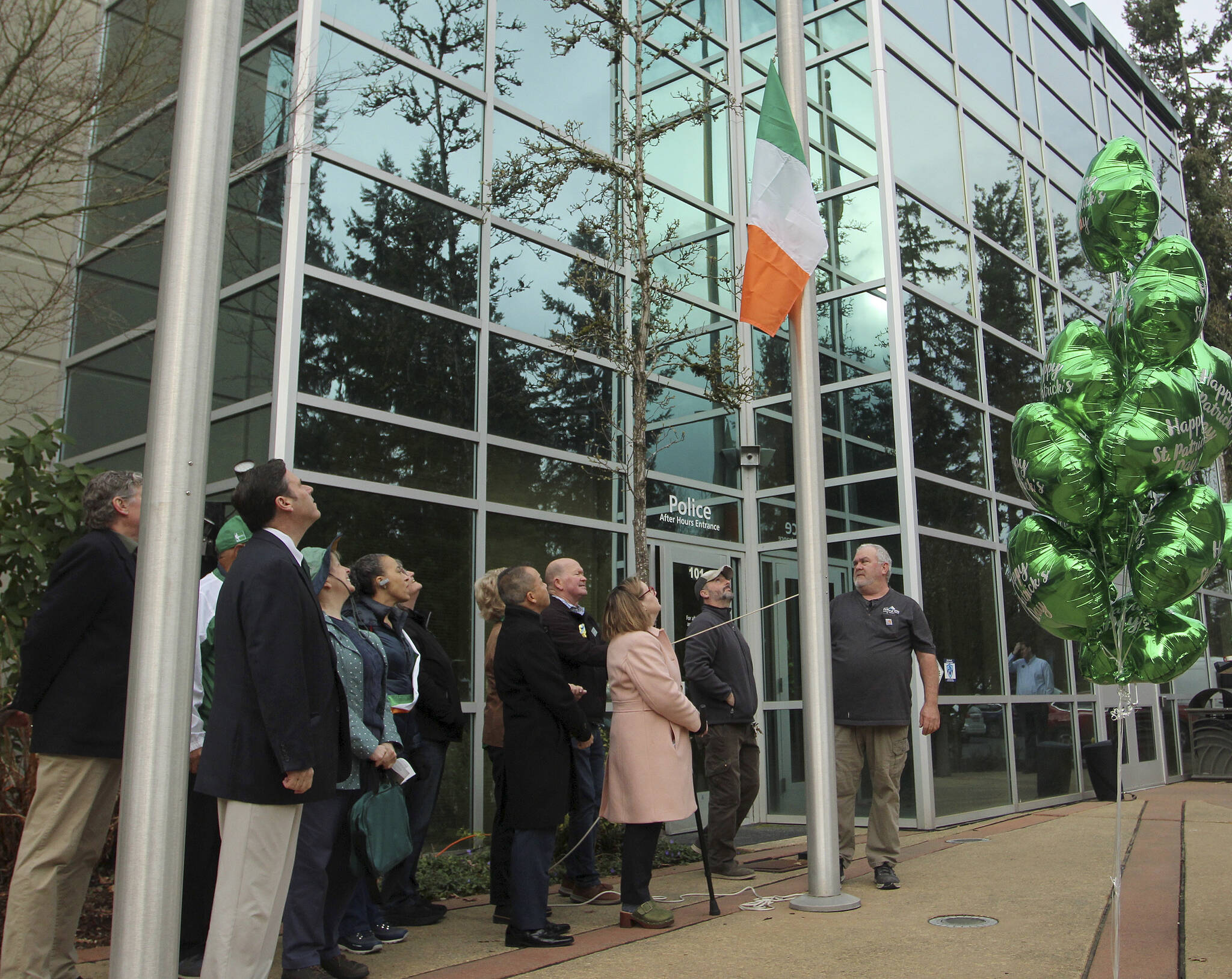 Elected officials and proud community members with Irish heritage assist in raising the Irish flag on March 17.