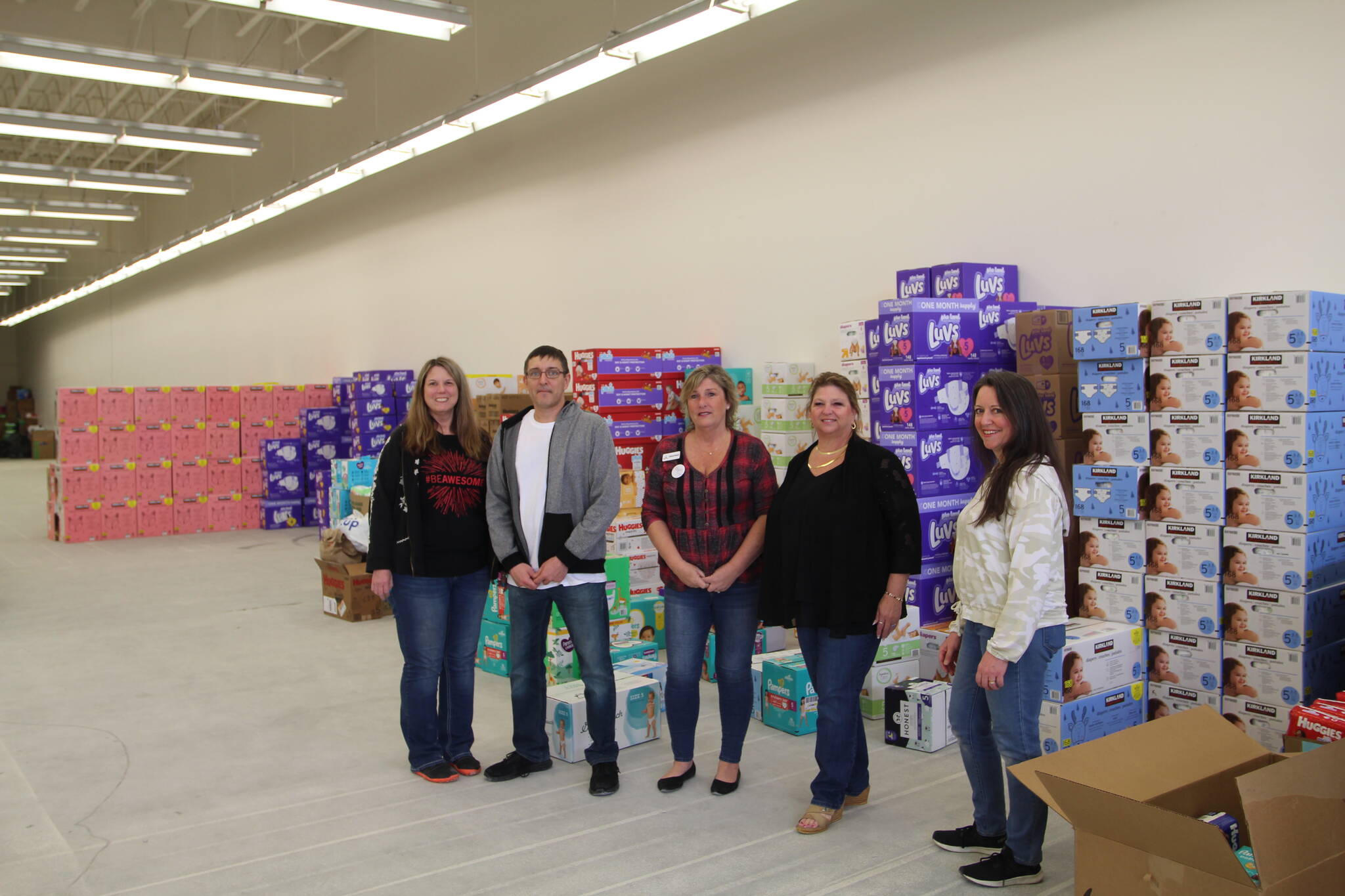 Olivia Sullivan/the Mirror
Nonprofit founder Cheryl Hurst, center, with volunteers Karlyn Devereaux, Joe Hutchinson, Cari Franklin and Anna Patrick inside an empty retail space in Federal Way where thousands of diapers were stored during the March of Diapers event.