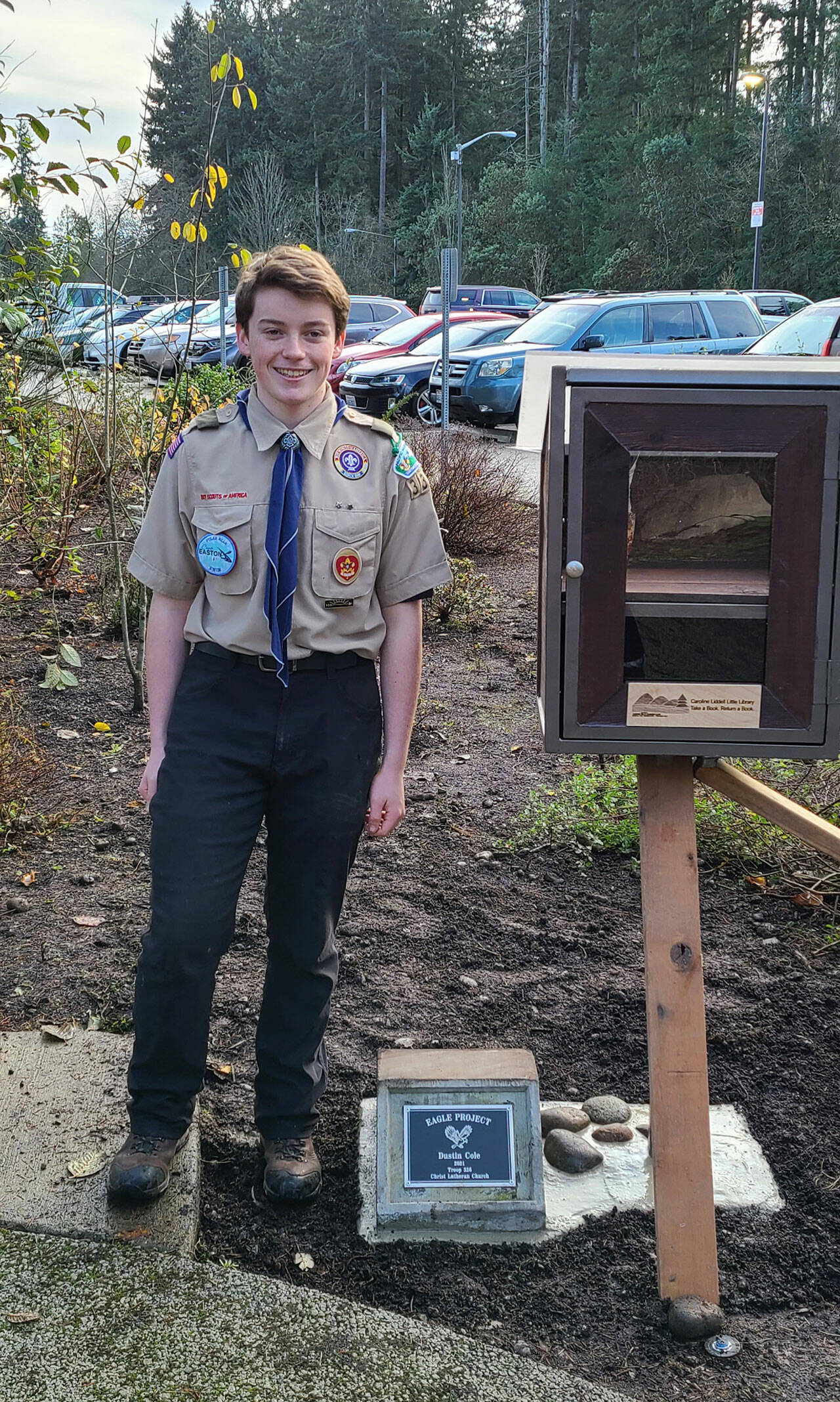 Boy Scout Dustin Cole next to the Little Free Library near Panther Lake Trail. Courtesy photo