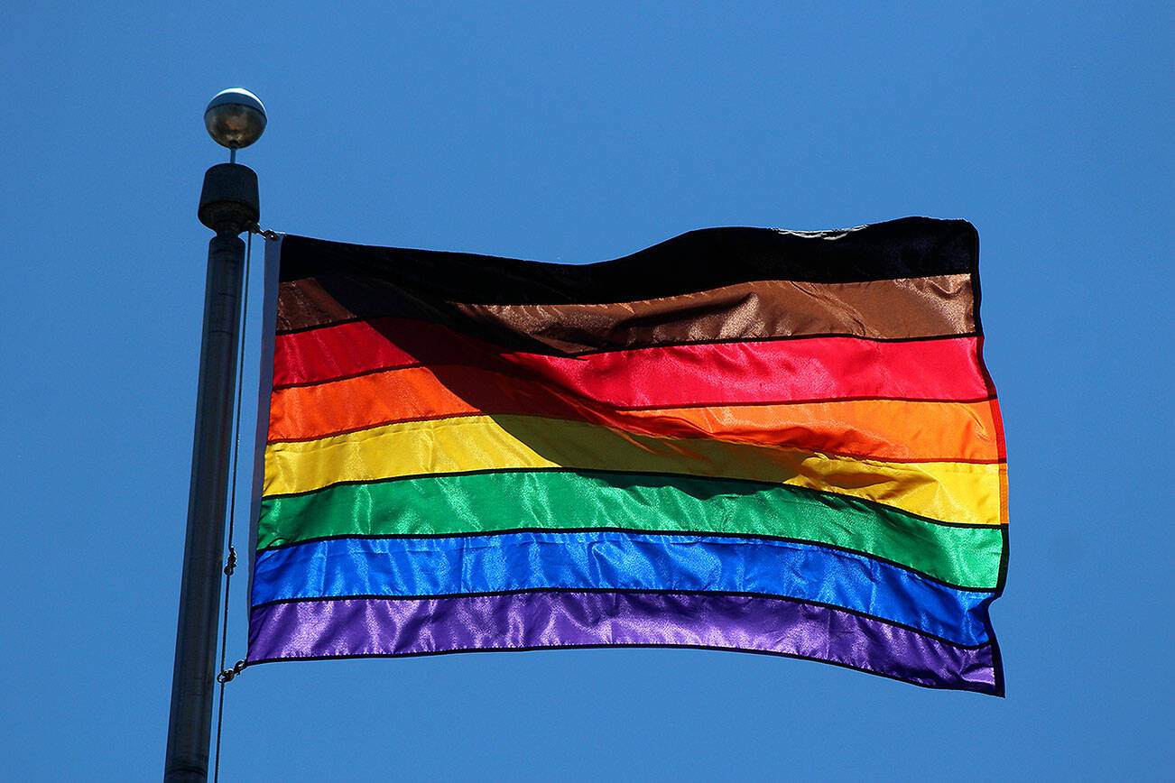 The diversity pride flag flying above Federal Way City Hall in June 2021. In addition to the traditional six colors, the flag also includes a black stripe for diversity and a brown stripe for inclusivity. Olivia Sullivan/the Mirror