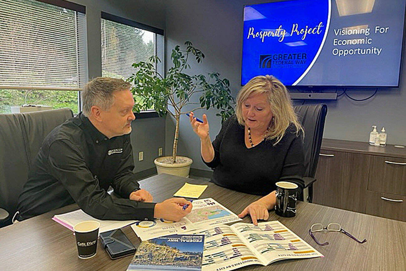 Courtesy photo
Chamber CEO Rebecca Martin reviews researched data with Board Chair Dan Eisenman, CEO Equalus, in preparation of for launch of Prosperity Project, a new economic development visioning effort led by the business community.