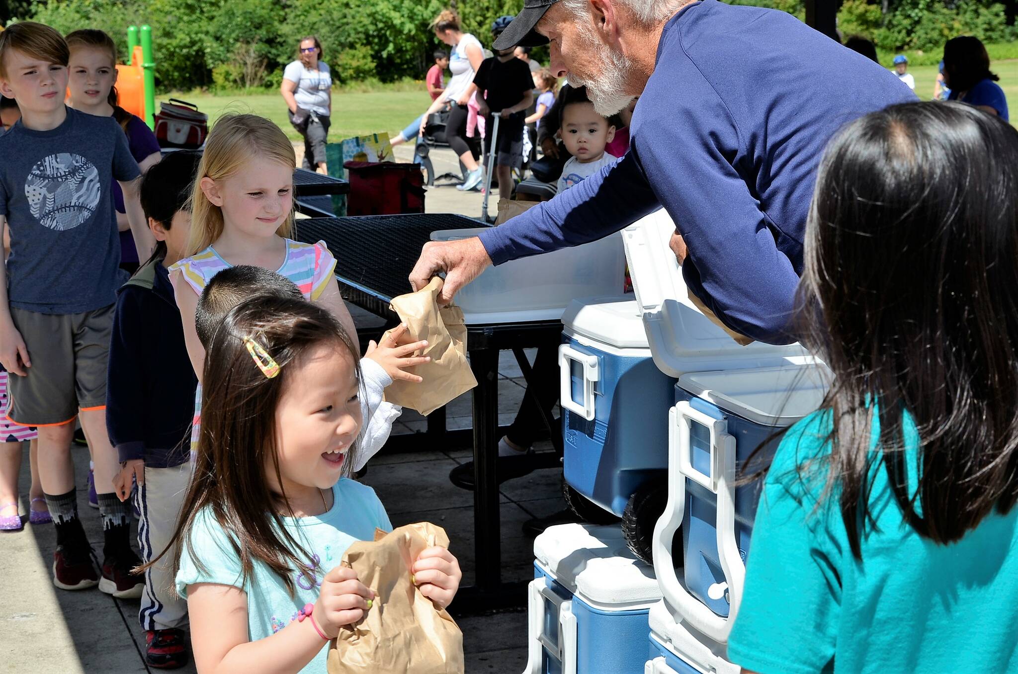 Children grab their free bag lunch through the Renton Summer Meals program. Photos courtesy of Renton School District.