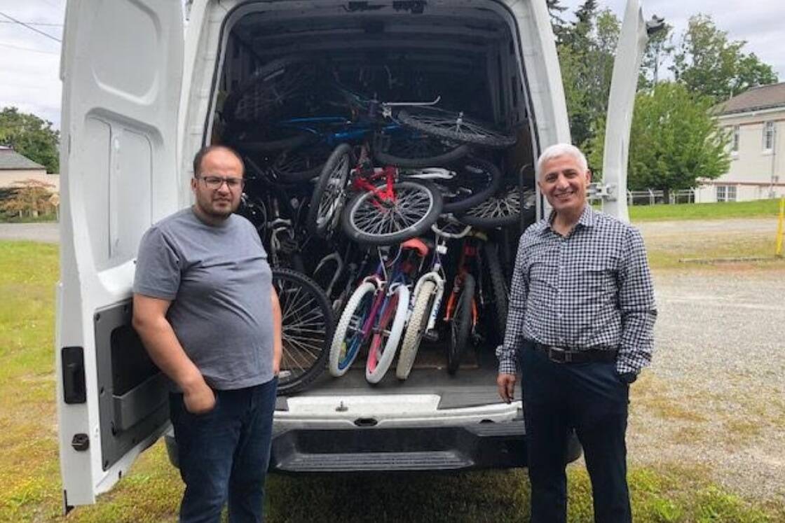 There’s no room to spare in the Lutheran Community Services Northwest van as staff members Mohammad Musa Salangi (left) and Aziz Ahmad Zaheer pick up donations from the Bikes for Kids organization. Courtesy photo