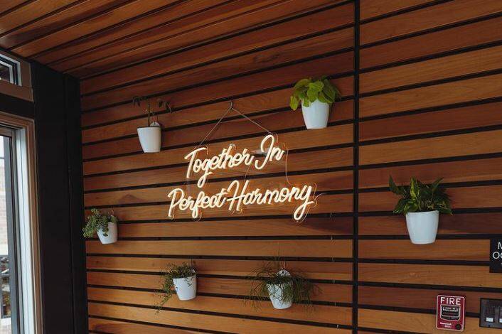 This neon sign at Ebony and Ivory reads "Together in Perfect Harmony," the business's motto. Ebony & Ivory Coffee photos.
