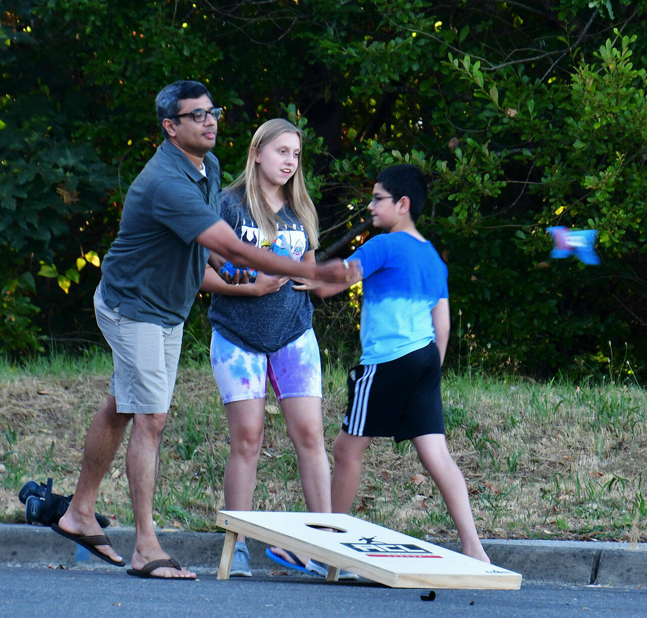 A local resident makes a toss playing cornhole on Aug. 2. Photo by Bruce Honda