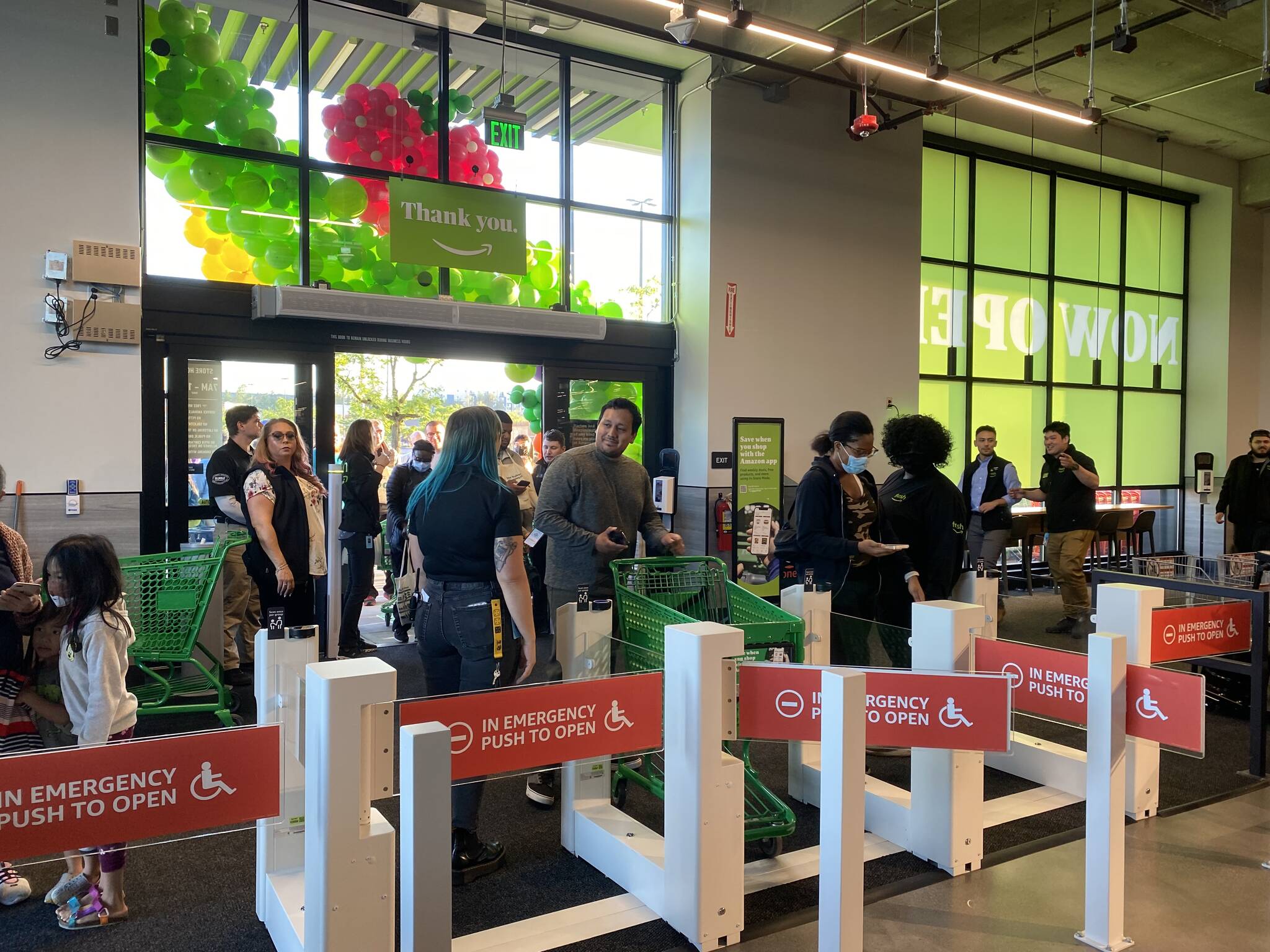 People scan to enter the Amazon Fresh store on Aug. 11. Scanning their app allows the customer to later skip the traditional checkout and charges their card using Just Walk Out technology. Olivia Sullivan/the Mirror