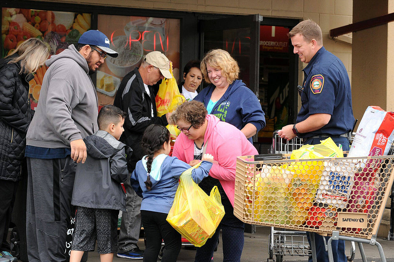 In this 2018 file photo, community volunteers gather with South King Fire and Rescue volunteers to collect donations for the annual Mayor’s Day of Concern for the Hungry. Photo courtesy of Shelley Pauls