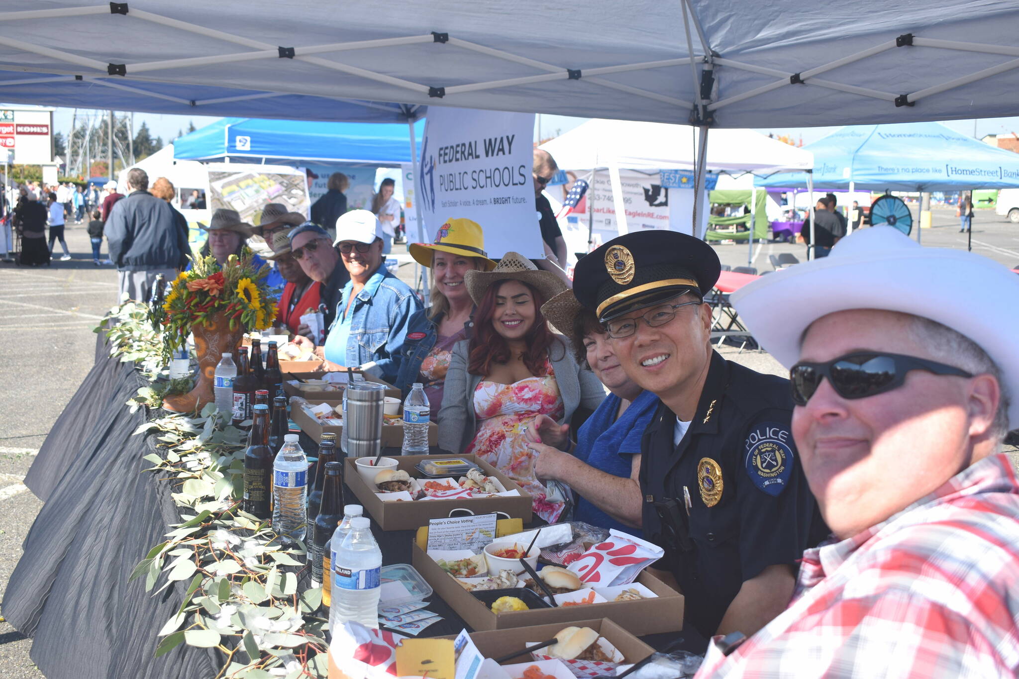 The judges table at the Taste of Federal Way smiles for a picture. The judges, not in order, were: King County Councilmember Pete von Reichbauer, Federal Way Police Chief Andy Hwang, South King Fire Rescue Assistant Fire Chief Kevin Crossen, Sound Transit Community Outreach Specialist Alonzo Buckner, Federal Way Public Schools Superintendent Dr. Dani Pfeiffer, Mary Ann Sharp from Heritage Bank, Federal Way Licensing Services owner Jan Novak, Keller Williams Agent Vickie Chynoweth, and Home Street Bank Branch Manager Arvin Kumar.
