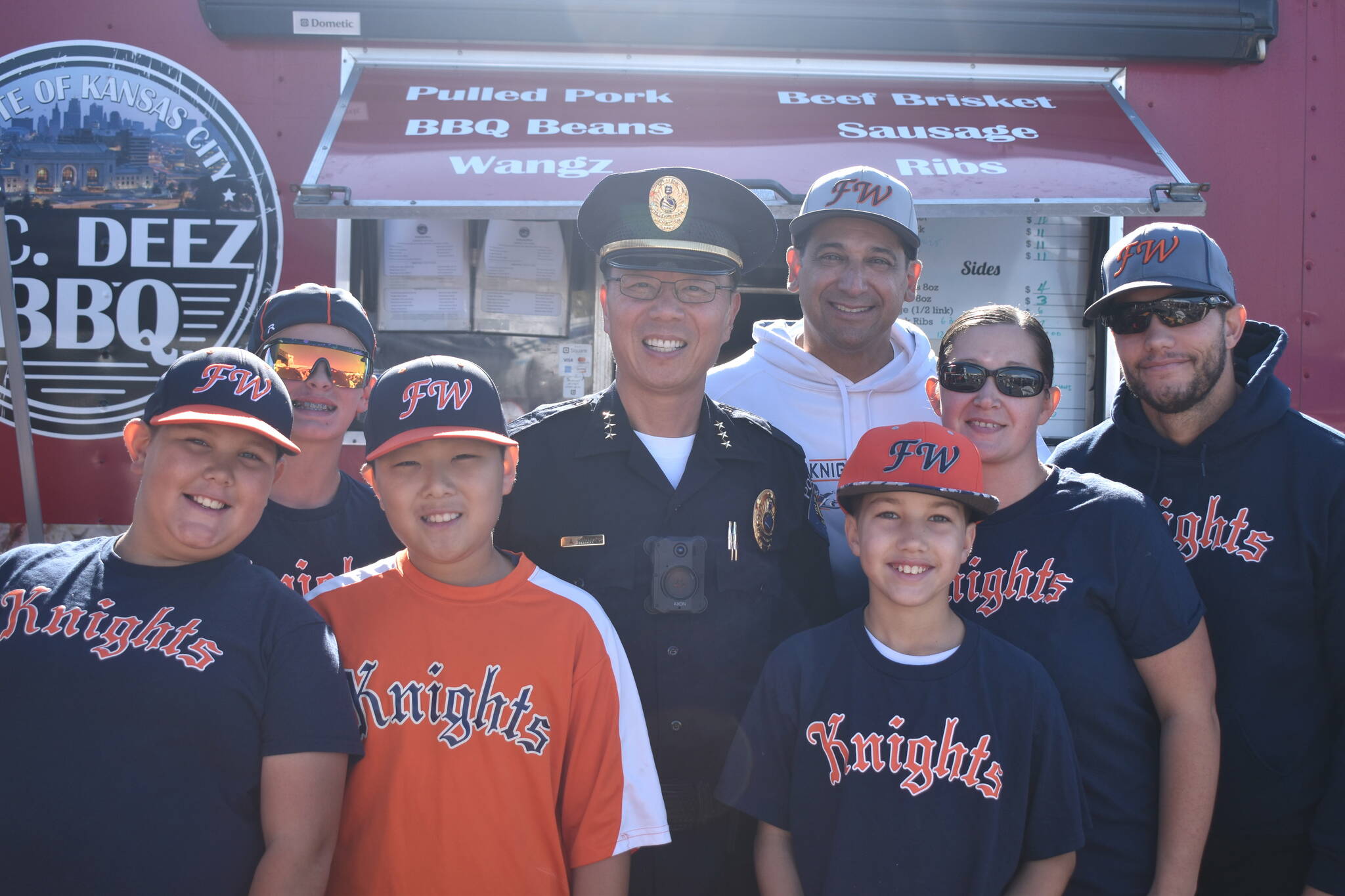 The Federal Way Knights Baseball team, pictured here with Federal Way Police Chief Andy Hwang, was awarded for selling the most tickets to the Taste of Federal Way.