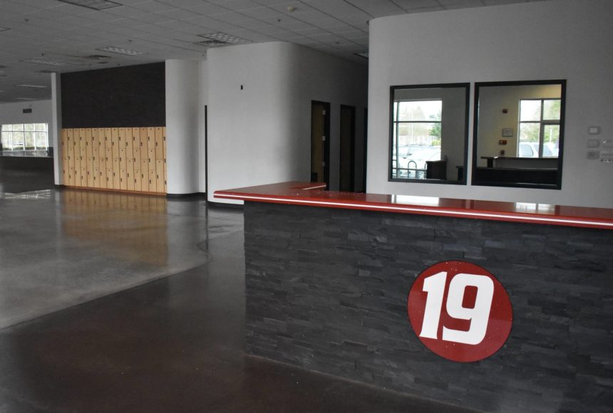 <p>Inside Fitness 19, all that is left is the lockers and the company’s logo desk as of November. Ben Ray/the Mirror</p>
