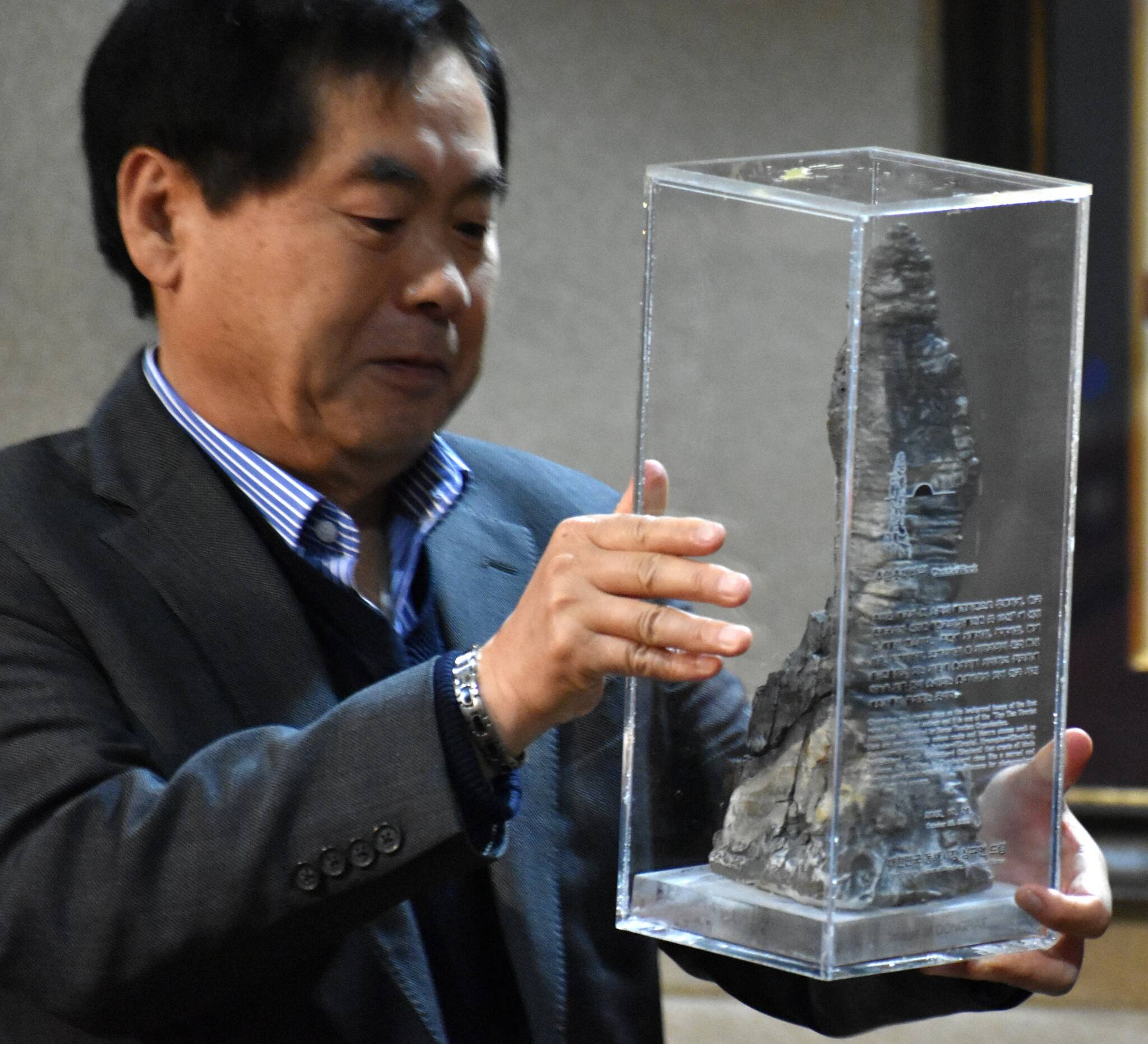 Federal Way received a Plaque of Appreciation and a unique, eye-catching rock from the beaches of Donghae City, its sister city in South Korea since 2000. Former Mayor Michael Park presented the plaque and gave a brief presentation about Donghae City during the Dec. 6 city council meeting. In this photo, Park presents the unusual-looking rock gifted by mayor Shim Gyu-eon.