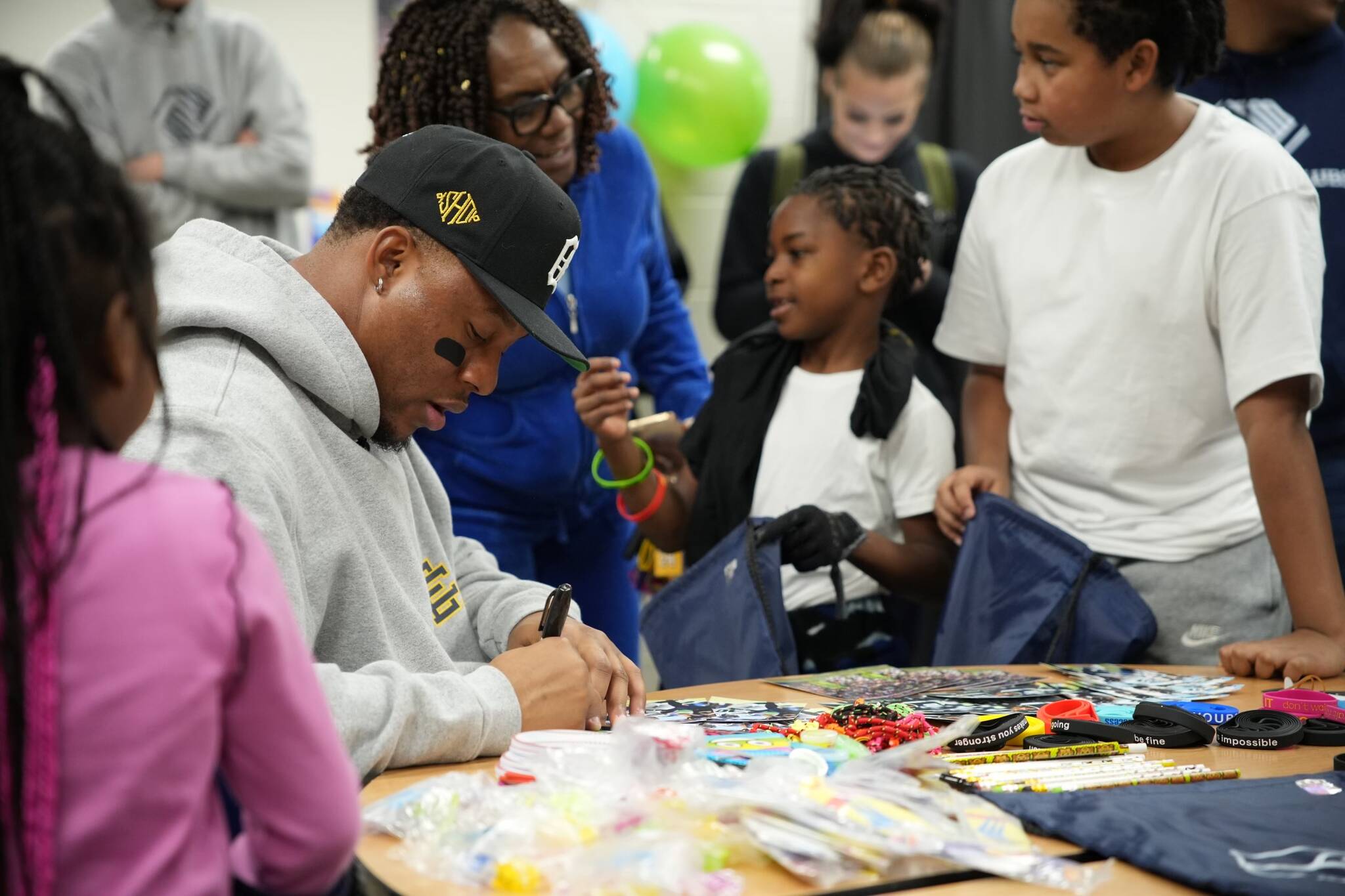 Uchenna Nwosu signs goodie bags for kids at the Federal Way Boys and Girls Club on Dec. 5. Photo courtesy of the Seattle Seahawks