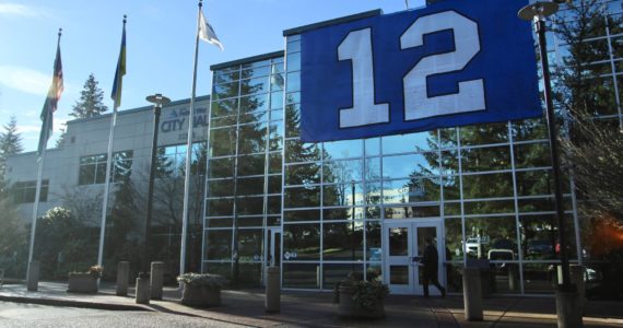 A man walks into Federal Way City Hall on Jan. 11 underneath the 12th Man flag hung in support of the Seattle Seahawks. Olivia Sullivan/the Mirror