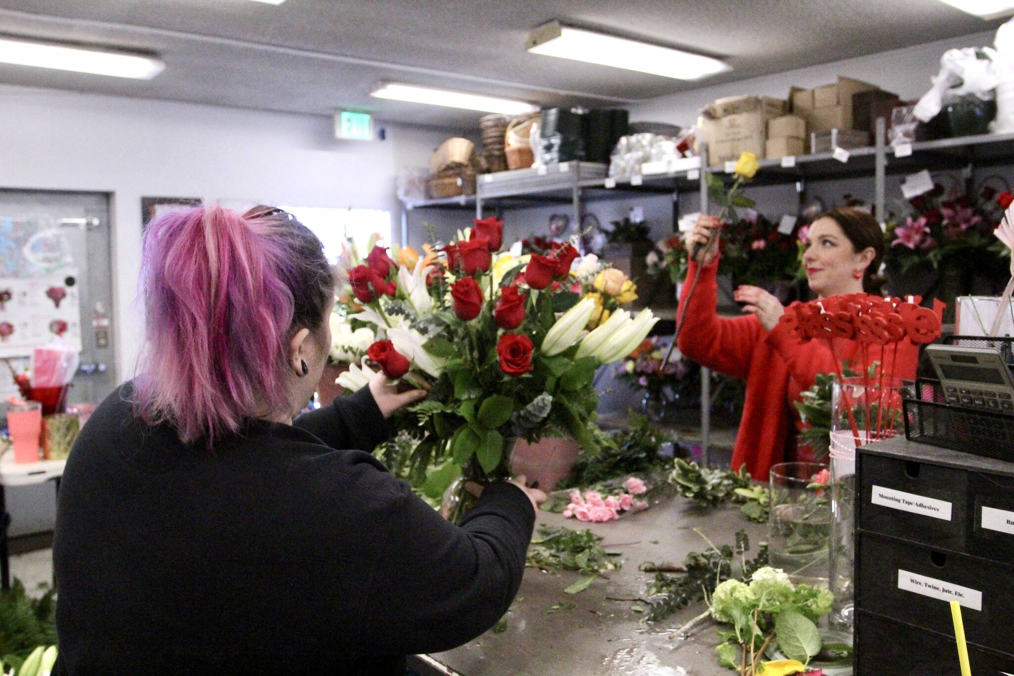 Employees Molly Bricker, left, and Brianna Sterling craft bouquets on Valentine’s Day at the Federal Way flower shop. Olivia Sullivan / the Mirror