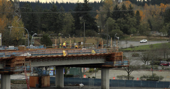 Construction workers work on the final stop of the Federal Way Link Extension light rail route along S. 320th Street in Federal Way on Nov. 19, 2021. Olivia Sullivan / the Mirror