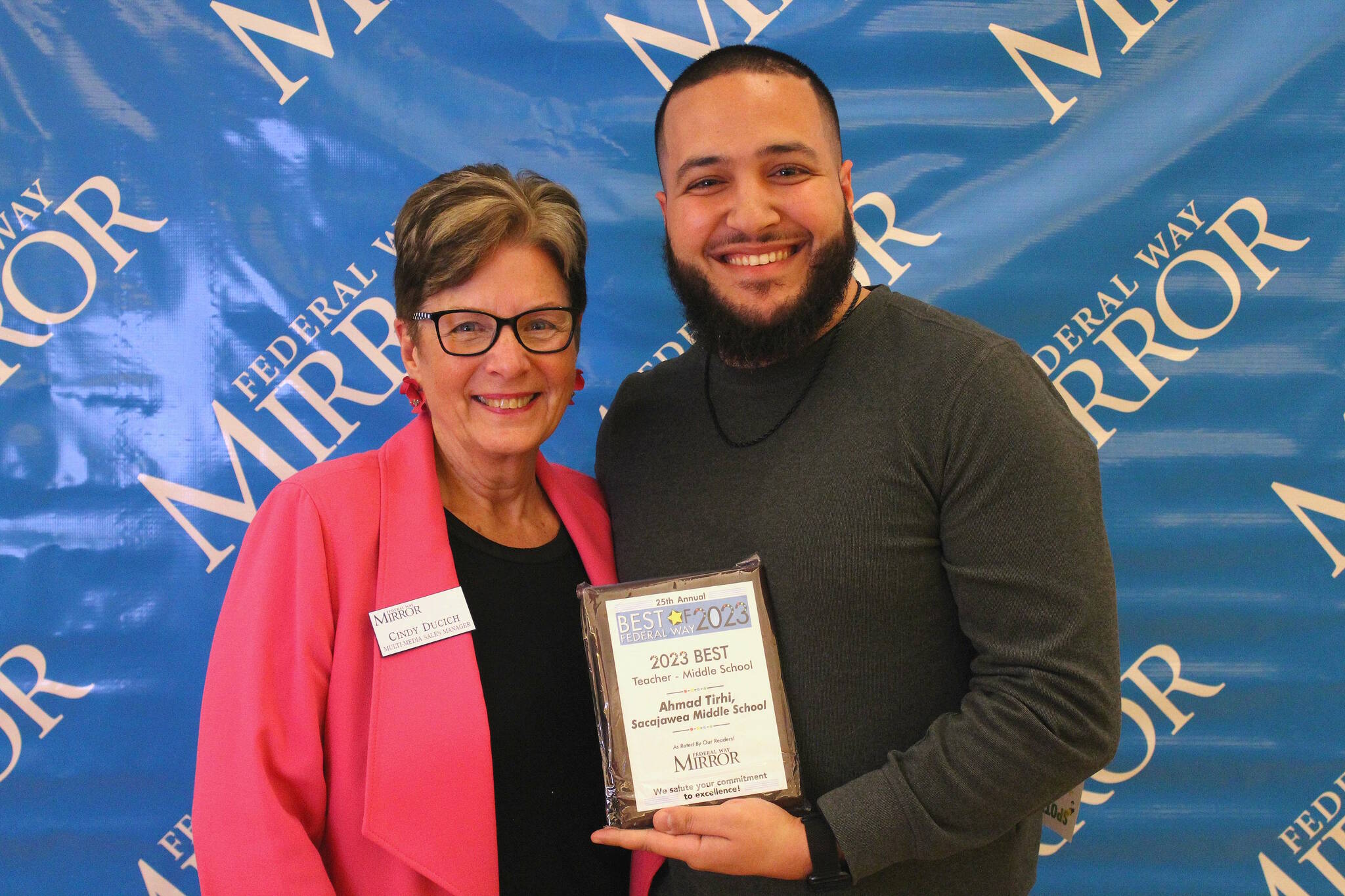 Federal Way Mirror Multi-Media Sales Manager Cindy Ducich stands with the Best Teacher - Middle School winner, Ahmad Tirhi of Sacajawea Middle School. Alex Bruell / The Mirror