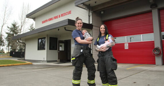 Olivia Sullivan / The Mirror
South King Fire and Rescue Lt. Ann Hoag, left, holds her son Flynn and firefighter Amanda Weed holds her daughter, Parker, outside Station 63 on March 9.