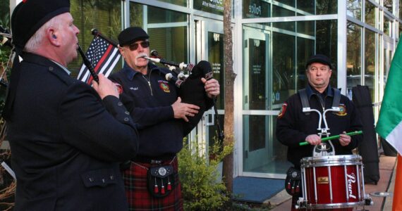 Neil Hubbard and two of the three present members of the Puget Sound Firefighters Pipes and Drums perform prior to the St. Patrick’s Day ceremony. Alex Bruell / The Mirror