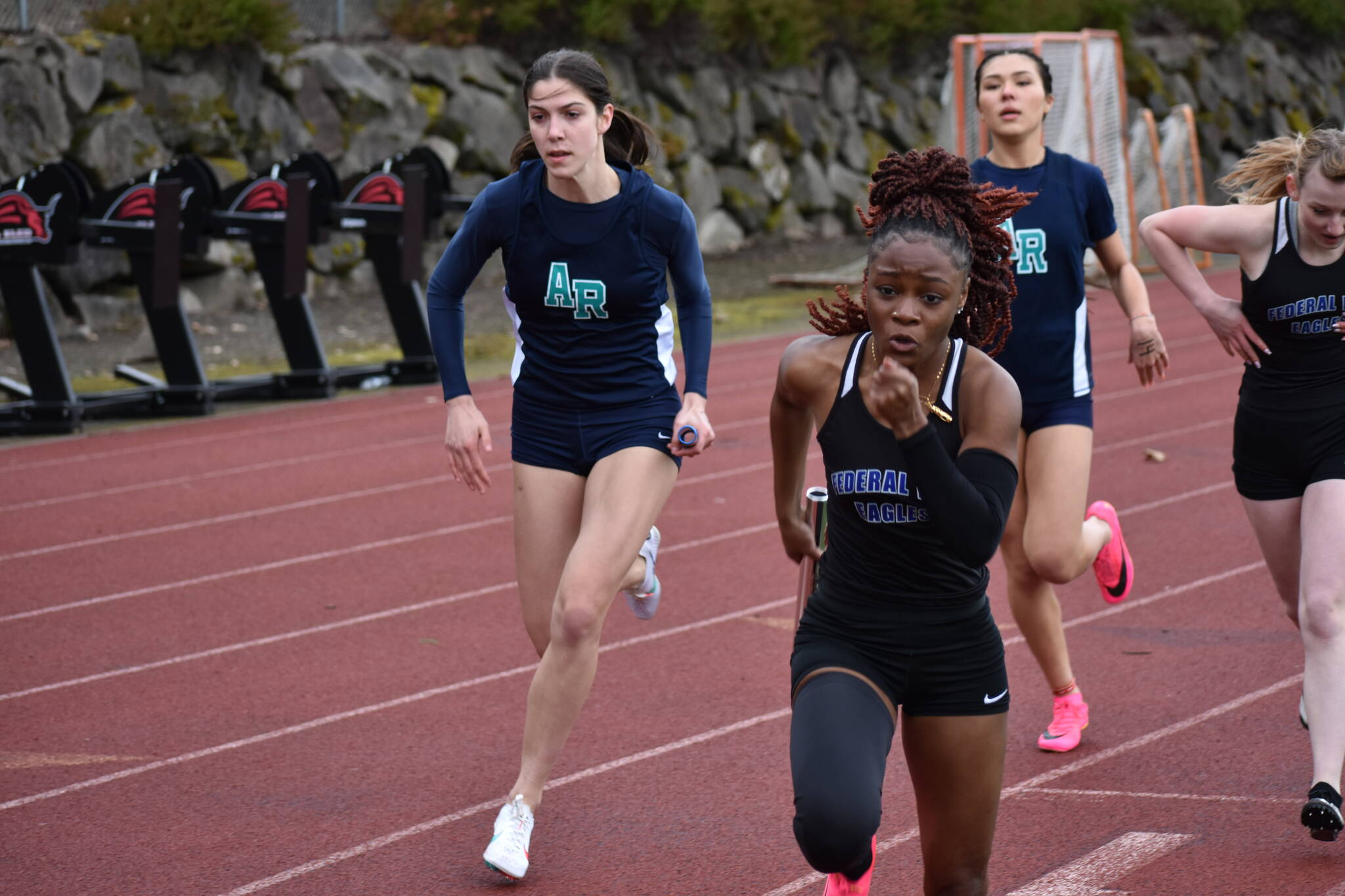 Federal Way’s Soukhanya Waters takes the baton for the anchor leg of the 4X200 relay.