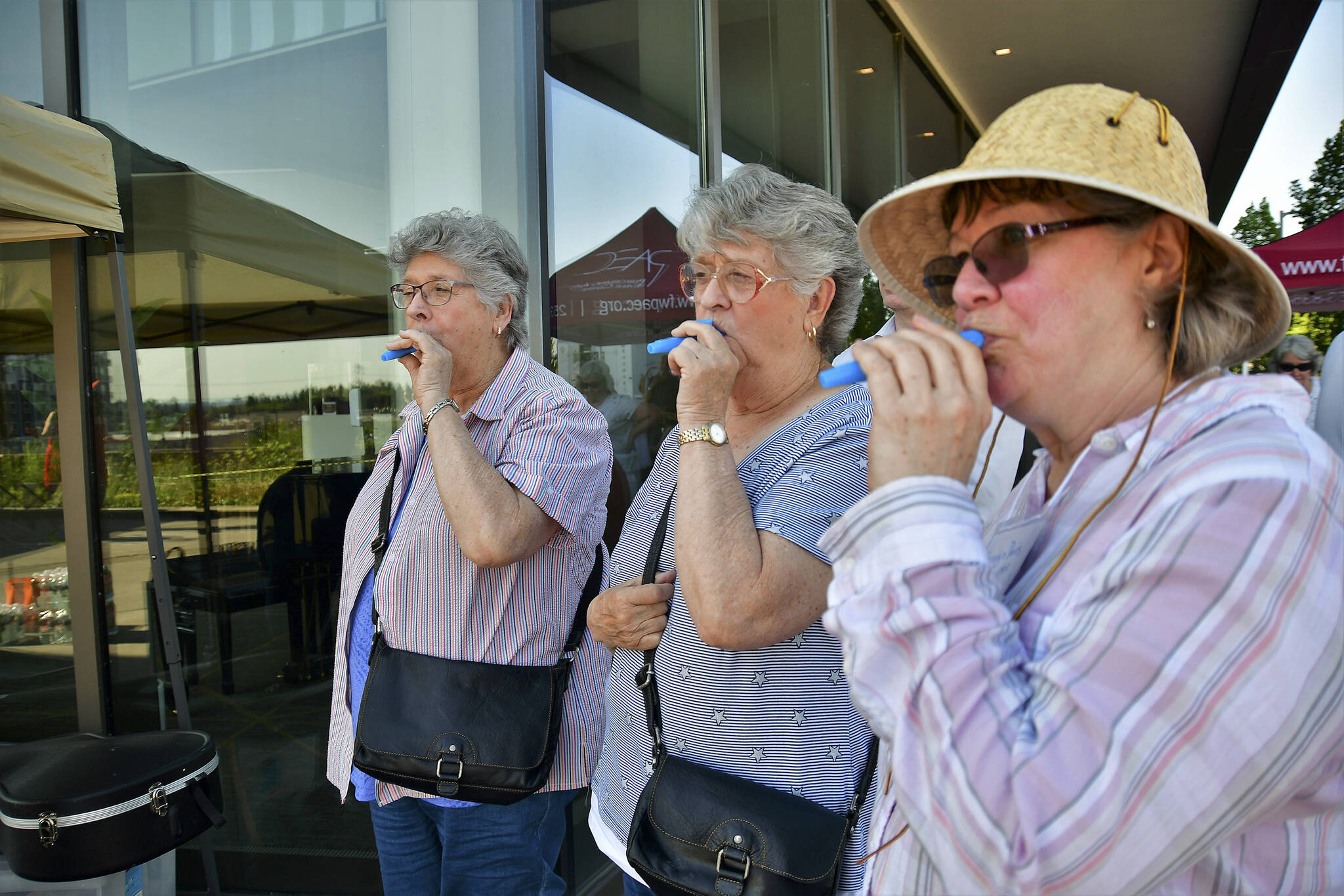Attendees of the June 21, 2021, Make Music Federal Way event play kazoos outside of the Federal Way Performing Arts and Event Center. Photo courtesy of Bruce Honda