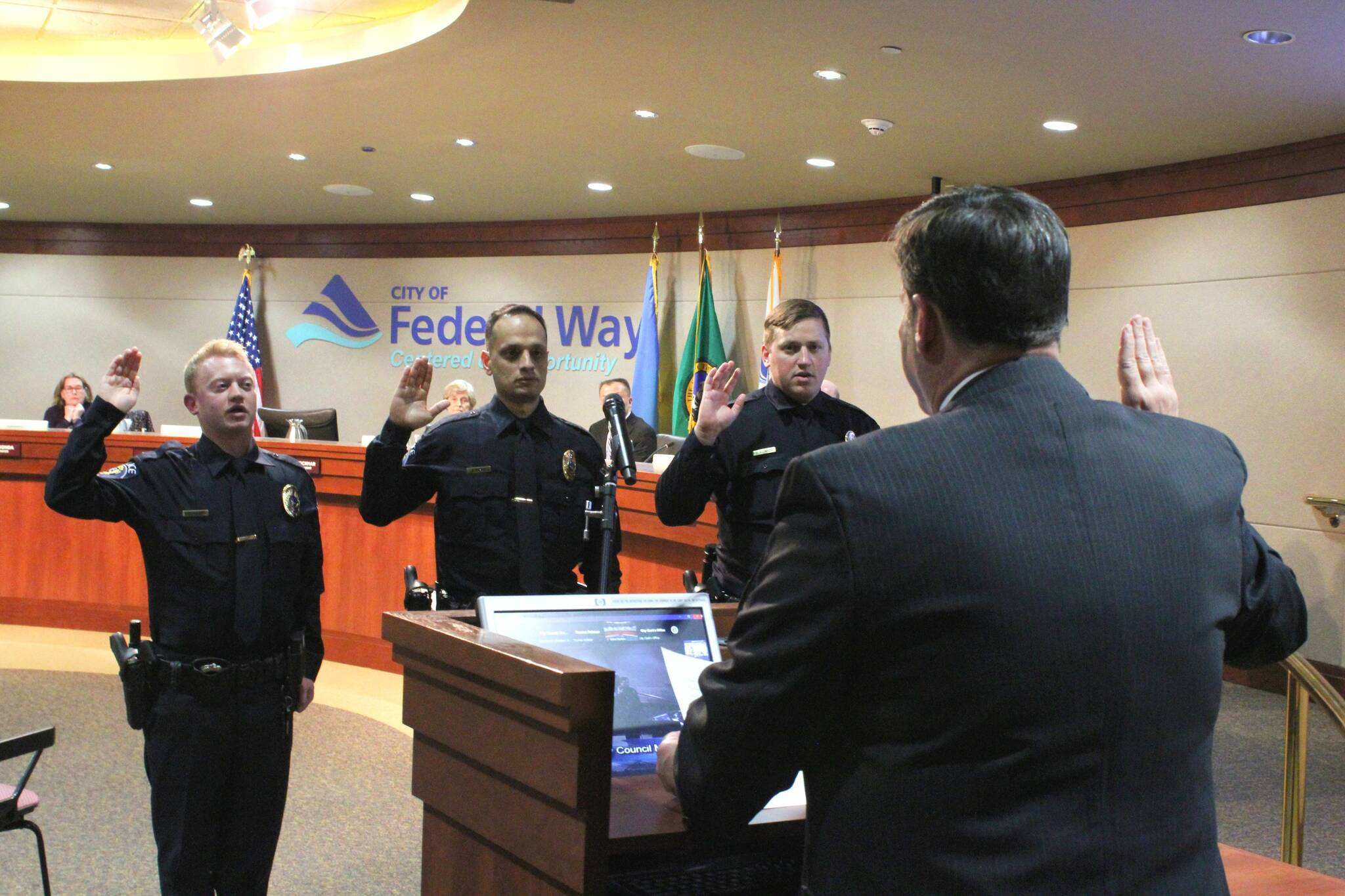 Alex Bruell / The Mirror
Mayor Jim Ferrell administers the oath of office to new Federal Way PD officers (from left to right) David Pollock, Adnan Ihsan and David Agapov during the April 18 City Council meeting.