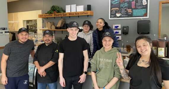 The Poverty Bay Cafe staff takes a moment to pose for a photo during a busy morning at the cafe on April 26. Olivia Sullivan / Federal Way Mirror