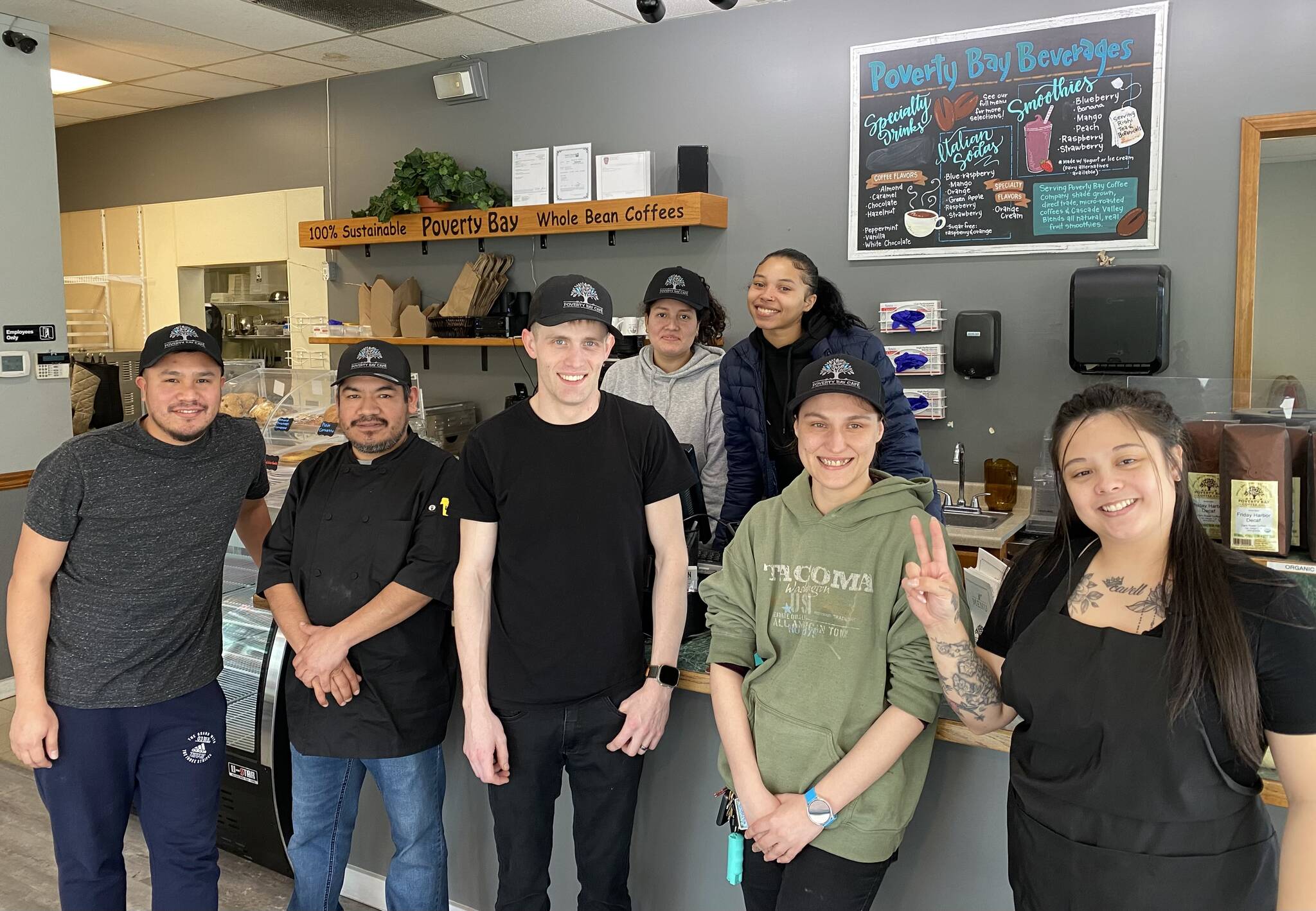 The Poverty Bay Cafe staff takes a moment to pose for a photo during a busy morning at the cafe on April 26. Olivia Sullivan / Federal Way Mirror