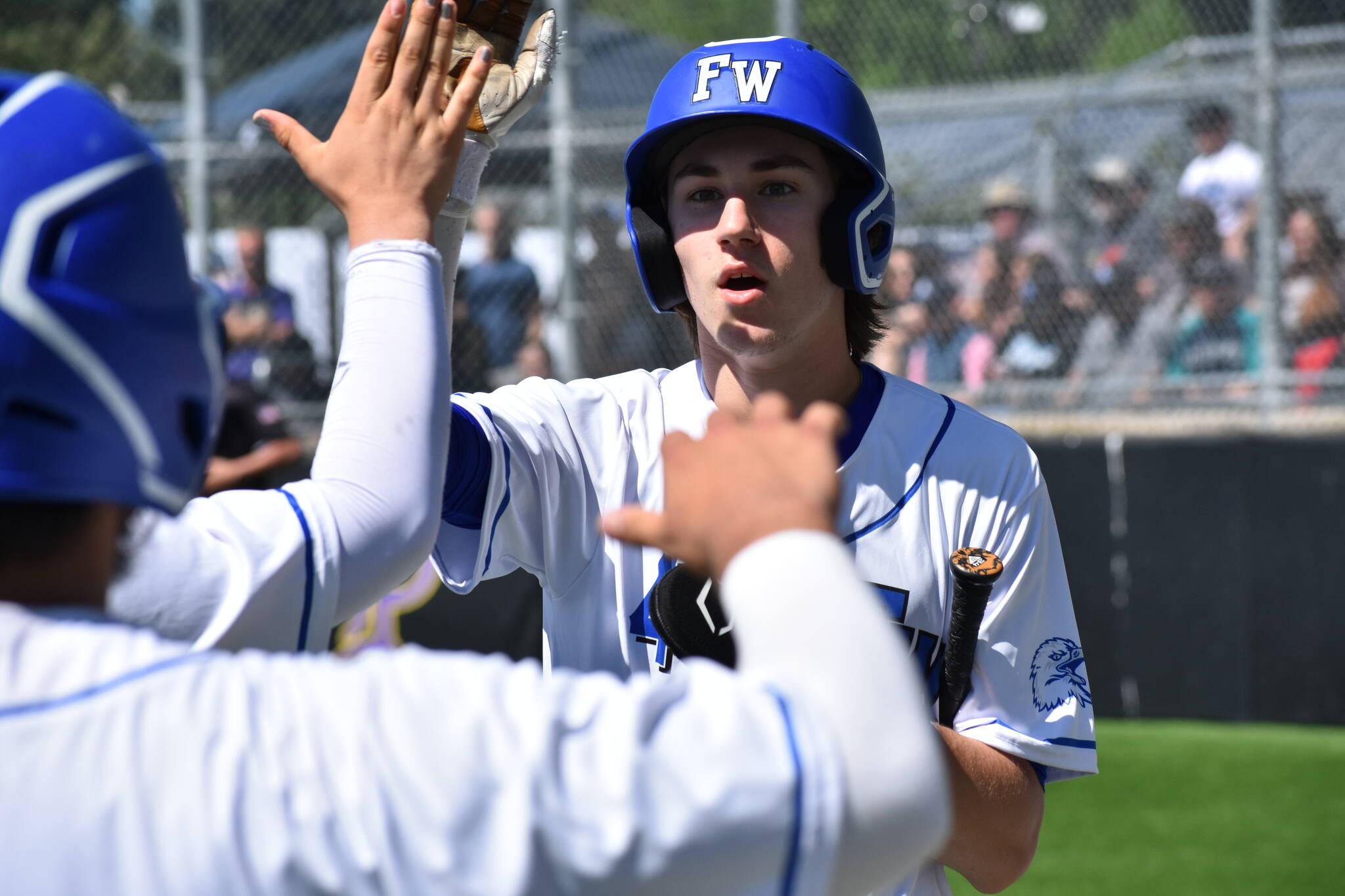 Jay O’Neill gets a lot of high fives as he scores the second run of the game for the Eagles. Ben Ray / The Mirror
