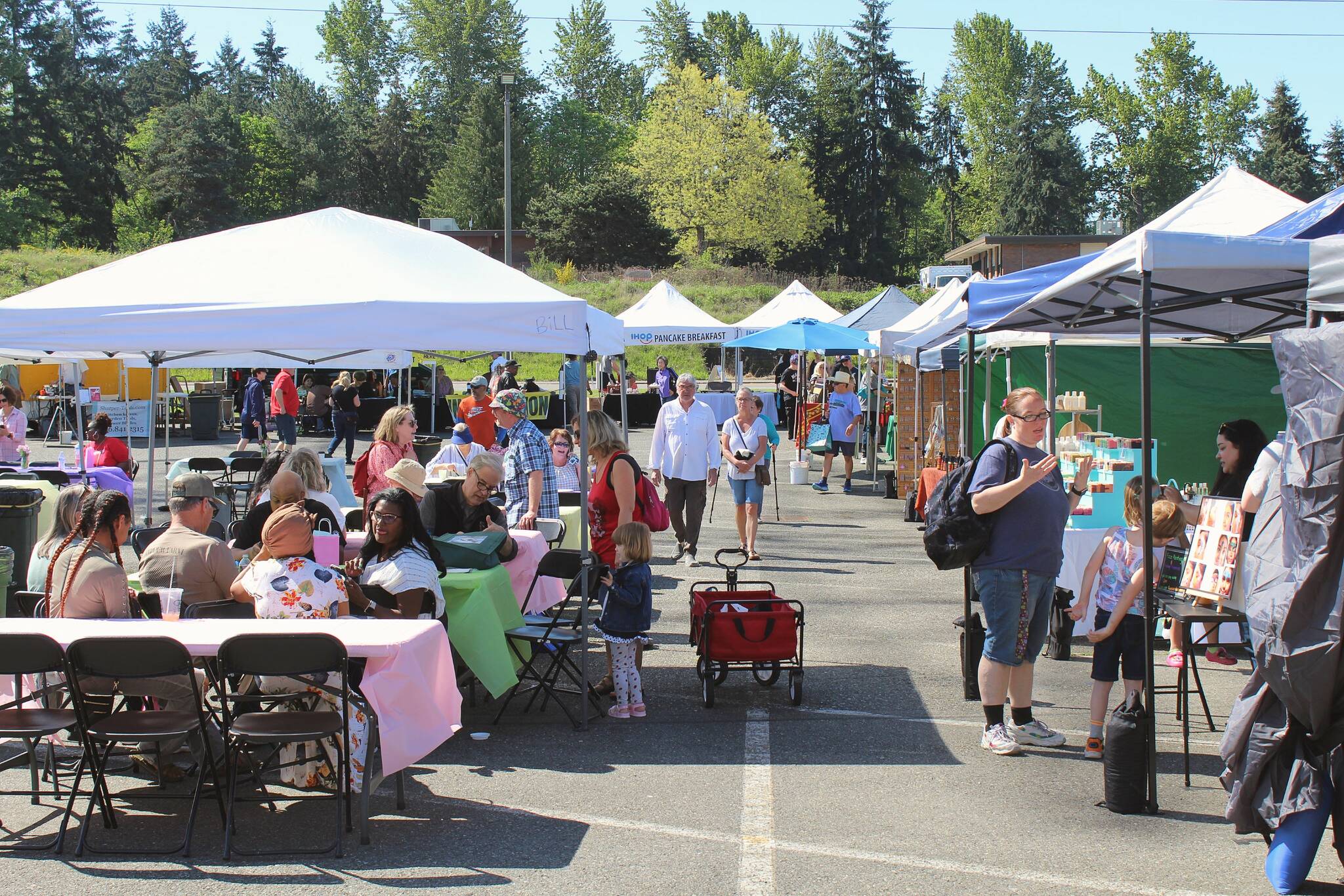 Alex Bruell / The Mirror 
Crowds explore the opening day May 13 of the 2023 Federal Way Farmers Market.