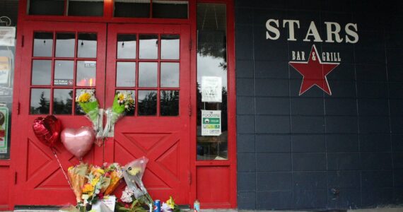 Alex Bruell / The Mirror 
Flowers and candles are left by the door of the Stars Bar & Grill in Federal Way, where two employees were shot and killed early Sunday morning, May 21, 2023. A third man was shot and taken to a hospital. Alex Bruell / The Mirror