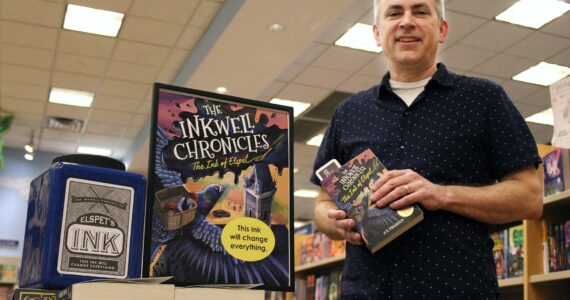 Alex Bruell / The Mirror 
JD Peabody holds a copy of his recently released book “The Ink of Elspet,” the first in his new series titled “The Inkwell Chronicles.” The books are for sale and on display at the Federal Way Barnes and Noble.