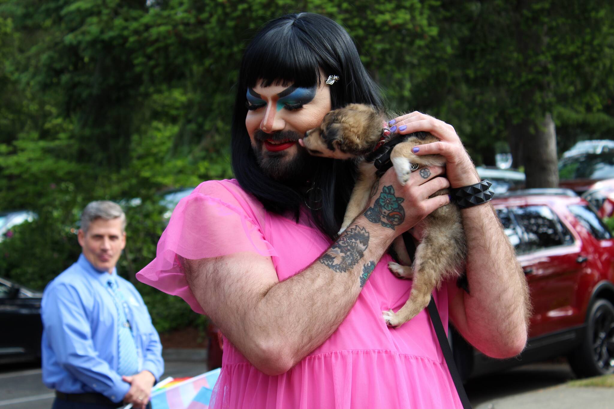 Drag queen Nemesis gets a kiss from a dog at the Federal Way pride flag raising. Alex Bruell / The Mirror