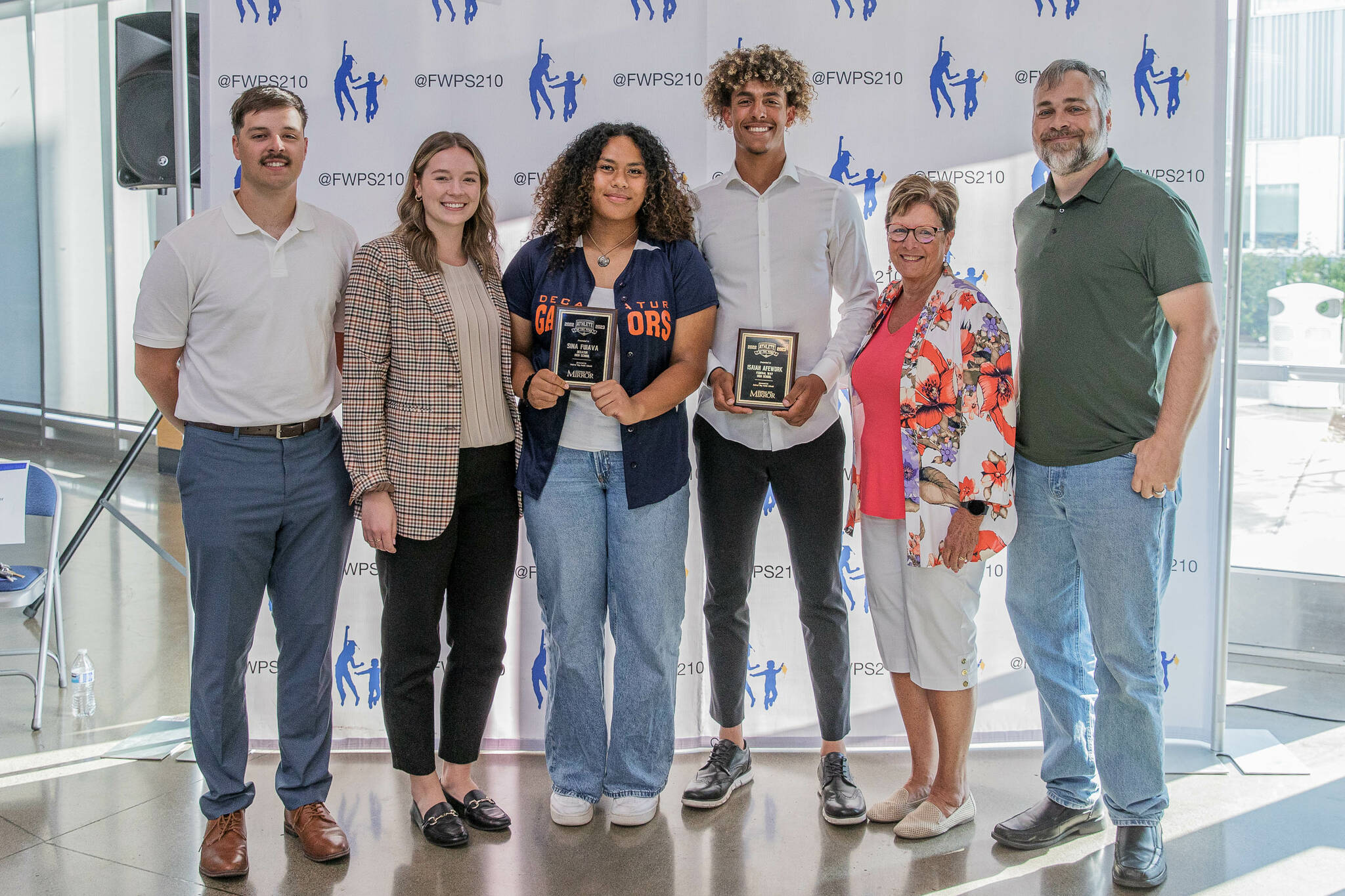 Mirror staff with winners. Pictured left to right: sports reporter Ben Ray, assistant editor Olivia Sullivan, Decatur High School’s Sina Fuiava, Federal Way High School’s Isaiah Afework, multimedia sales manager Cindy Ducich, and editor Andy Hobbs. Photo Provided by FWPS