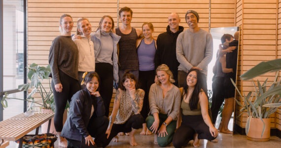 Photo courtesy of Expand Yoga 
Owners Matt Ottenbach, top row in the black hoodie, and Liz Houck, top row in the blue tank top, pose with several teachers at the new Federal Way yoga studio.