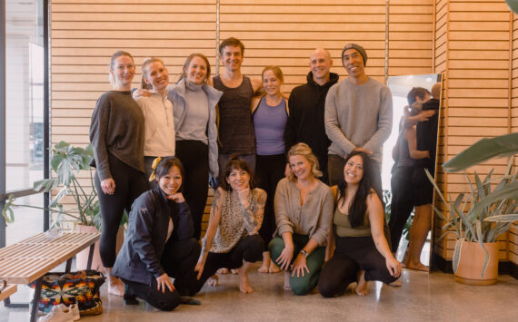 Photo courtesy of Expand Yoga 
Owners Matt Ottenbach, top row in the black hoodie, and Liz Houck, top row in the blue tank top, pose with several teachers at the new Federal Way yoga studio.