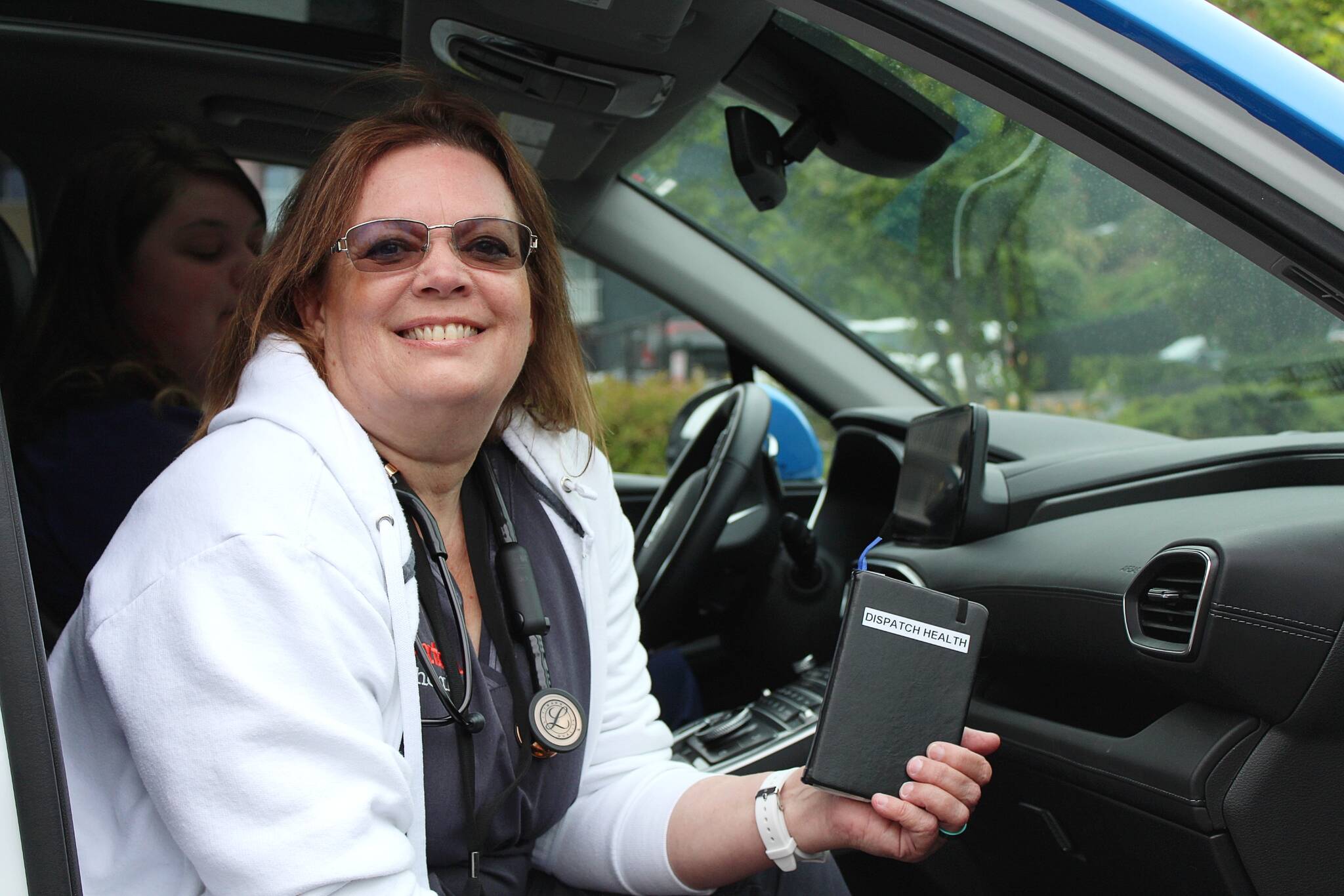 Nurse practitioner Sirena Sagdahl holds her black book of resources she carries while visiting patients through Dispatch Health. She and Sierra Berry, a Dispatch Health medical technician, teamed up the morning of July 21 to visit patients for the day. (Alex Bruell / The Mirror)