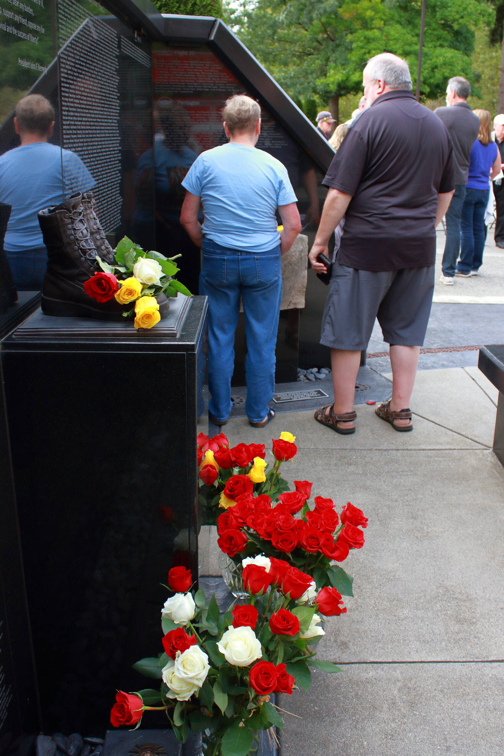 Community members view the permanant memorial display at Fire Station 64. Photo by Keelin Everly-Lang / The Mirror