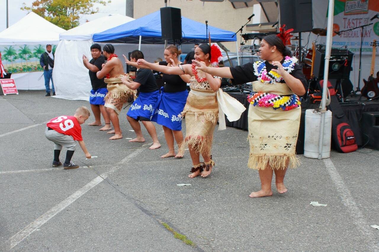 Photo by Keelin Everly-Lang/The Mirror
A local baseball player cheers on members of the Federal Way High School Pacific Islander Club dancers by participating in lafo during one of the dances at the Taste of Federal Way, held Sept. 23.
