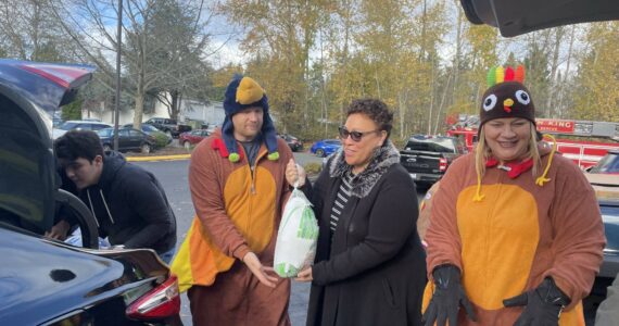 Volunteers got into the holiday spirit by dressing as Thanksgiving turkeys at a turkey donation event on Sunday. (Photo provided by Shelley Pauls)