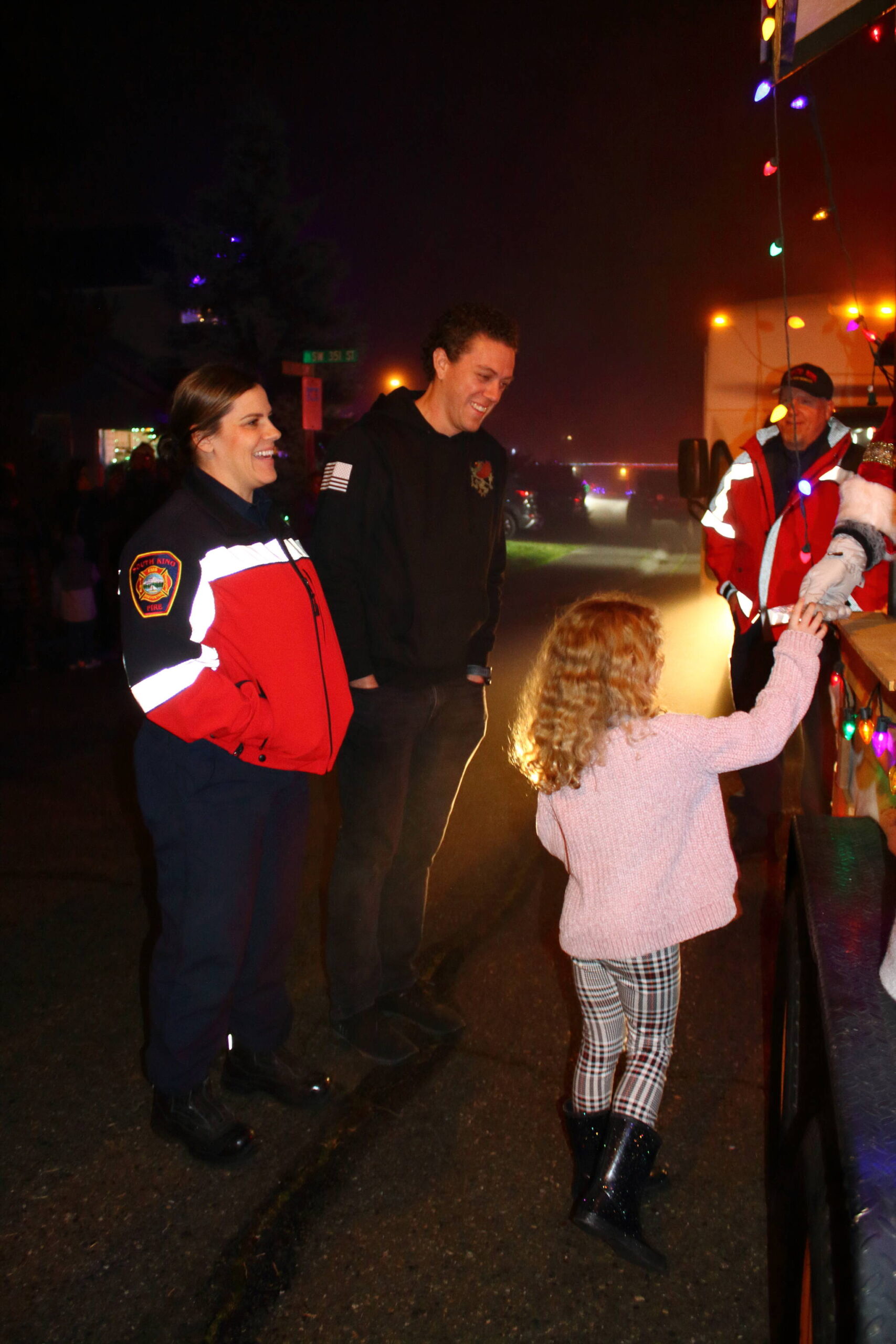 Captain Browning of South King Fire and her family enjoy the festivities while bringing joy to other families during the Santa Parade on Dec. 12. Photo by Keelin Everly-Lang / The Mirror