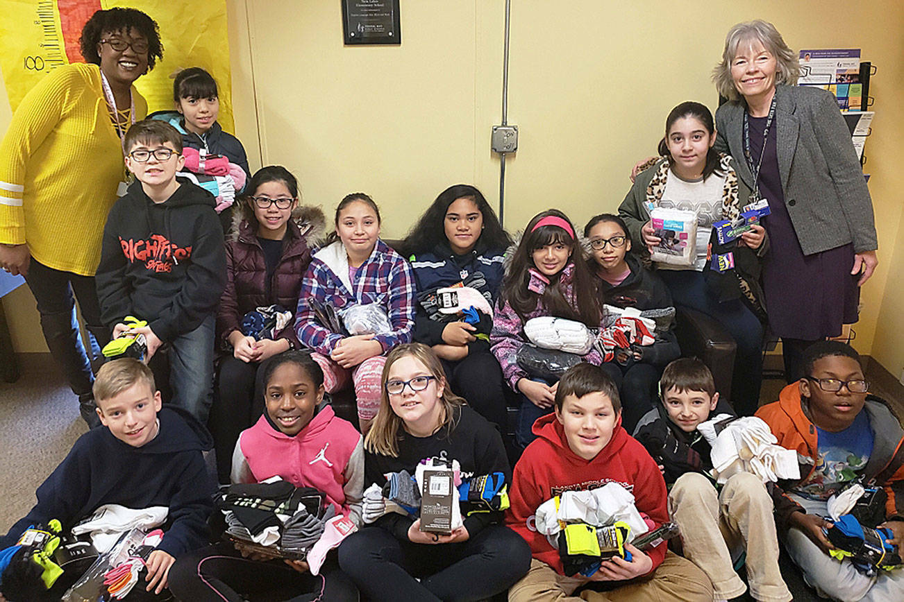 Danielle is pictured with students and another staff support who helped gather socks to donate to the Day Center in 2019. (File photo)