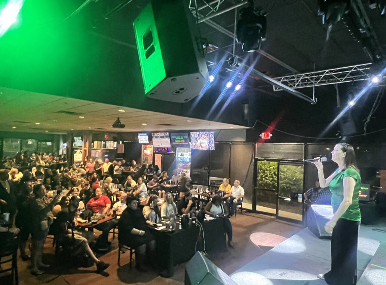 A karaoke singer competes in front of a packed crowd during the International Karaoke Federation’s competition last year. Photo provided by Garvaundo Hamilton.
