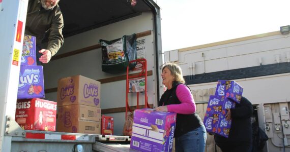 File photo
Cheryl Hurst, center, and other March of Diapers Drive volunteers help staff from Care Net of Puget Sound load thousands of diapers into U-Haul truck in this 2023 file photo. This year’s March of Diapers Drive will collect donations March 23 at Twin Lakes Fred Meyer from 10 a.m. to 2 p.m.