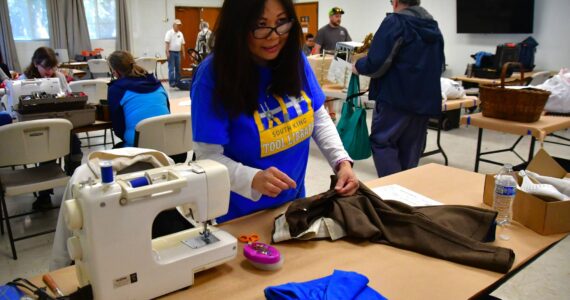 Sewing machines were available at Saturday’s event to help mend clothing in need of repair. Photo by Bruce Honda